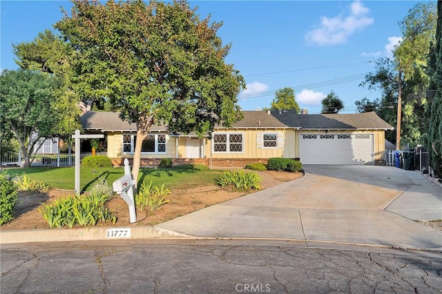 11777 Preston Ln, Yucaipa, CA 92399 - ranch-style house with a front lawn, driveway, a garage, brick siding, and board and batten siding