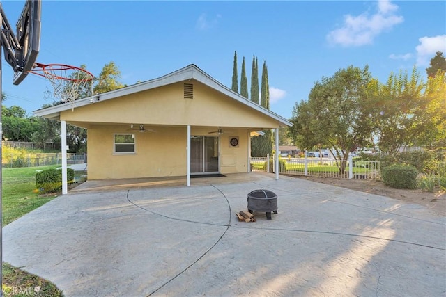 11777 Preston Ln, Yucaipa, CA 92399 - rear view of house featuring a ceiling fan, stucco siding, a fire pit, and a patio