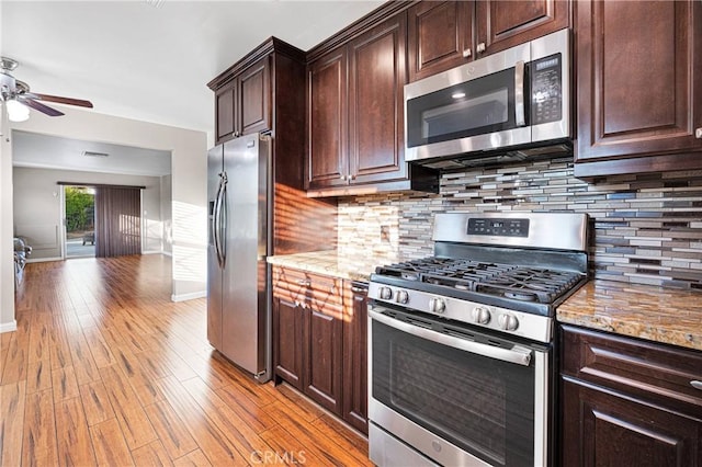 11777 Preston Ln, Yucaipa, CA 92399 - kitchen featuring stainless steel appliances, a ceiling fan, light stone counters, light wood-style flooring, and dark brown cabinetry
