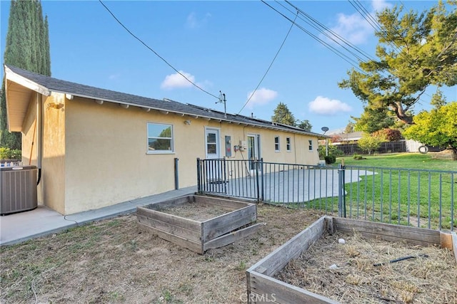 11777 Preston Ln, Yucaipa, CA 92399 - rear view of house with a vegetable garden and stucco siding