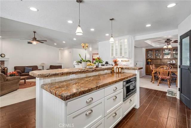 5215 Columbia Way, Lancaster, CA 93536 - kitchen with a ceiling fan, recessed lighting, open floor plan, dark wood finished floors, and glass insert cabinets