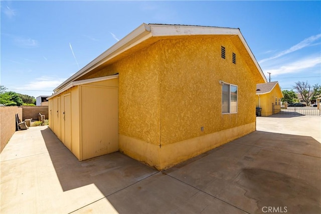 5215 Columbia Way, Lancaster, CA 93536 - view of side of home featuring a patio area and stucco siding