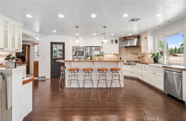 5215 Columbia Way, Lancaster, CA 93536 - kitchen featuring stainless steel appliances, wall chimney exhaust hood, decorative backsplash, recessed lighting, and a sink