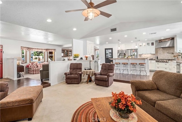 5215 Columbia Way, Lancaster, CA 93536 - living area with vaulted ceiling, ceiling fan, recessed lighting, and light colored carpet