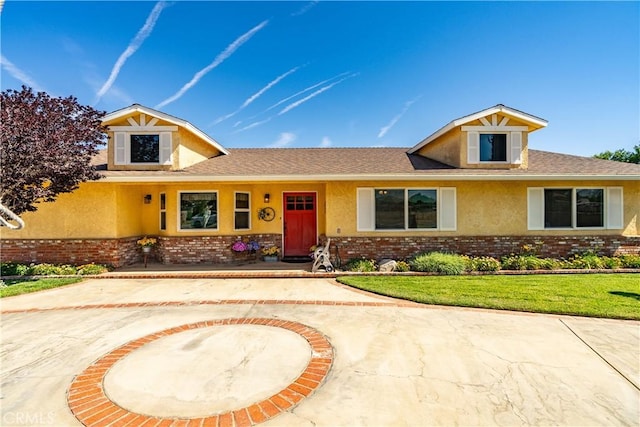 5215 Columbia Way, Lancaster, CA 93536 - view of front of home with brick siding, stucco siding, and a front yard