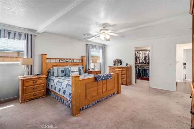 5215 Columbia Way, Lancaster, CA 93536 - bedroom with light carpet, a closet, a walk in closet, a textured ceiling, and beam ceiling