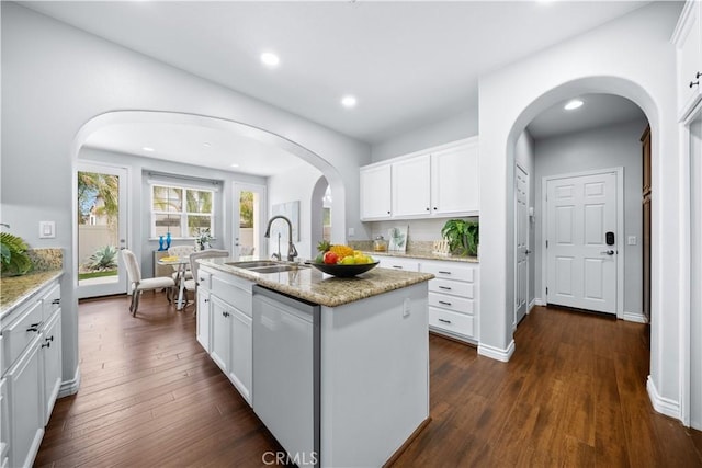 46239 Lone Pine Dr, Temecula, CA 92592 - kitchen featuring dishwasher, a sink, a kitchen island with sink, light stone counters, and white cabinetry