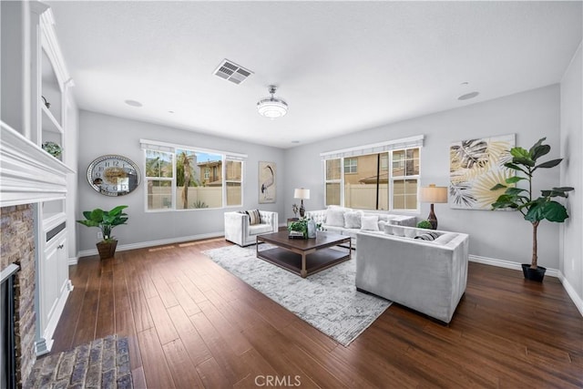 46239 Lone Pine Dr, Temecula, CA 92592 - living area with a stone fireplace, dark wood-type flooring, and baseboards