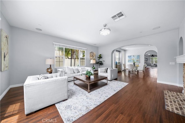 46239 Lone Pine Dr, Temecula, CA 92592 - living room featuring arched walkways, wood finished floors, and baseboards