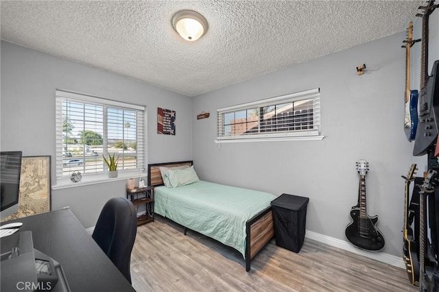 15326 Leffingwell Rd, Whittier, CA 90604 - bedroom featuring multiple windows, a textured ceiling, wood finished floors, and an office area