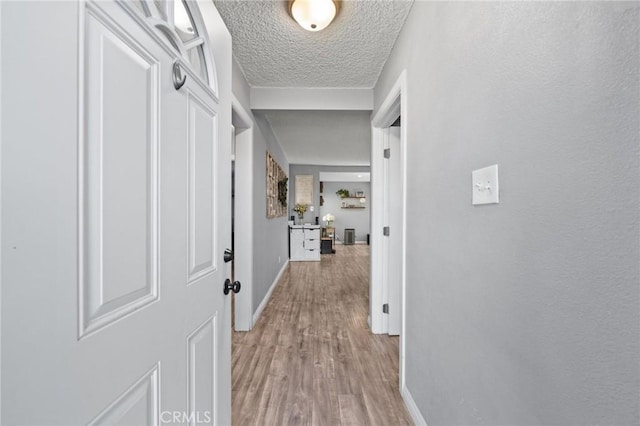 15326 Leffingwell Rd, Whittier, CA 90604 - hall with light wood-style floors and a textured ceiling
