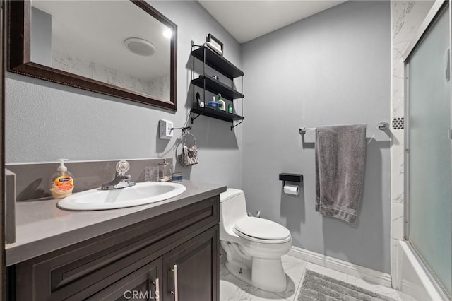 15326 Leffingwell Rd, Whittier, CA 90604 - bathroom featuring vanity, marble look tile flooring, and combined bath / shower with glass door