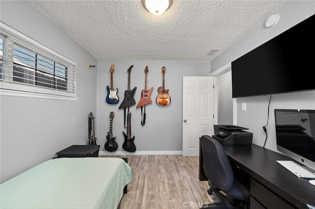 15326 Leffingwell Rd, Whittier, CA 90604 - bedroom with light wood finished floors, a textured ceiling, and a desk