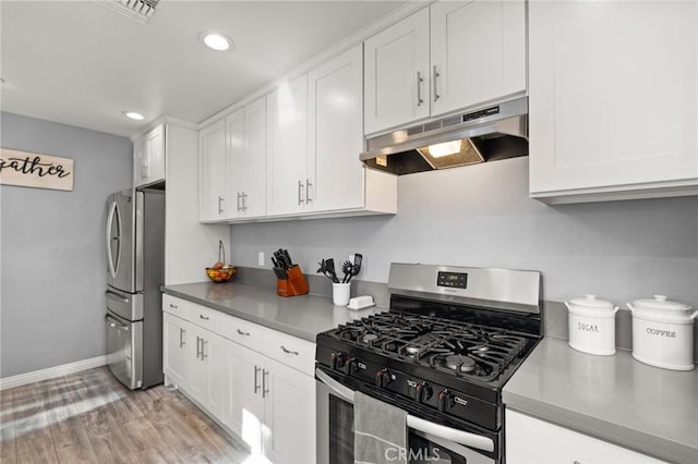 15326 Leffingwell Rd, Whittier, CA 90604 - kitchen with stainless steel appliances, under cabinet range hood, white cabinetry, recessed lighting, and light wood-type flooring