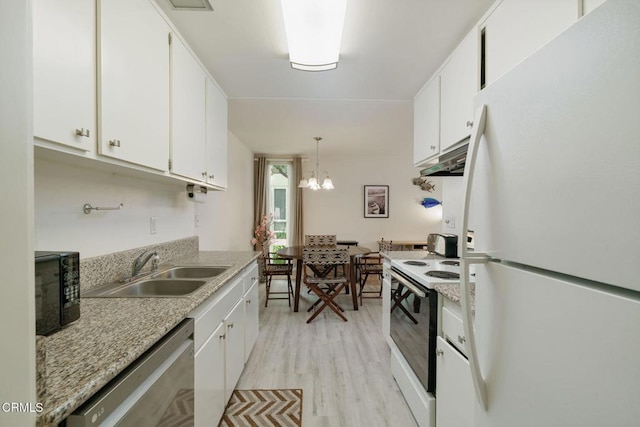 3700 Dean Dr Unit 1805, Ventura, CA 93003 - kitchen with white appliances, a sink, light wood finished floors, and white cabinets