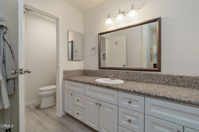 3700 Dean Dr Unit 1805, Ventura, CA 93003 - bathroom featuring vanity, wood finished floors, and toilet