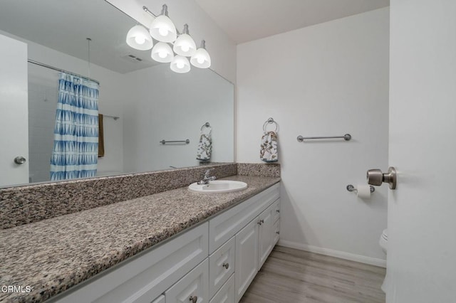 3700 Dean Dr Unit 1805, Ventura, CA 93003 - full bathroom featuring vanity, toilet, baseboards, wood finished floors, and curtained shower