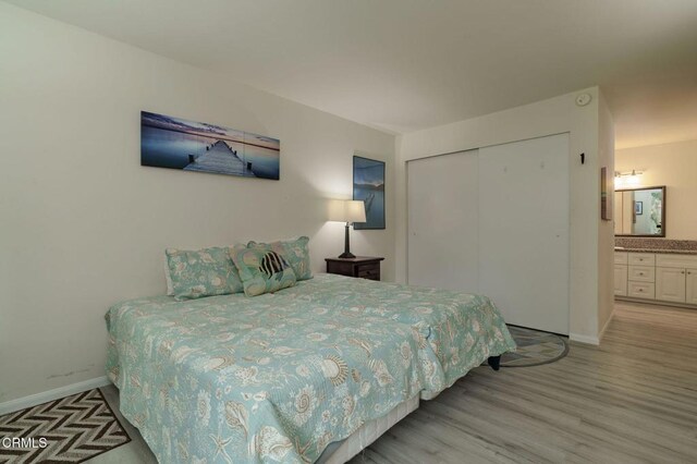 3700 Dean Dr Unit 1805, Ventura, CA 93003 - bedroom featuring a closet, light wood finished floors, and connected bathroom