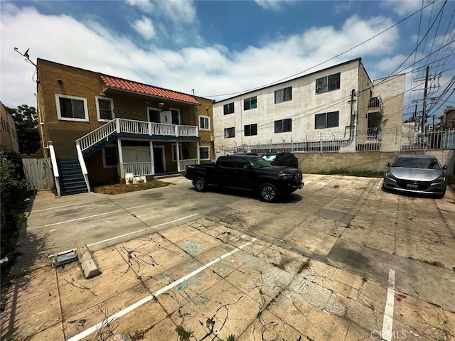 1136 Arapahoe St, Los Angeles, CA 90006 - view of property featuring uncovered parking and stairs