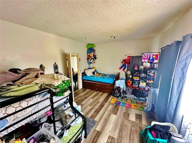 1136 Arapahoe St, Los Angeles, CA 90006 - bedroom with a textured ceiling and wood finished floors