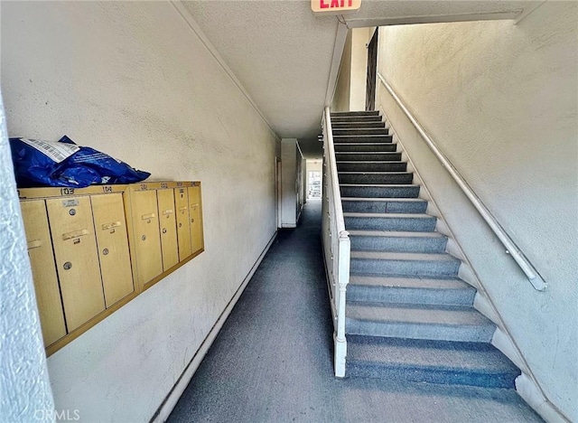 1136 Arapahoe St, Los Angeles, CA 90006 - staircase with a textured wall, mail area, a textured ceiling, and carpet