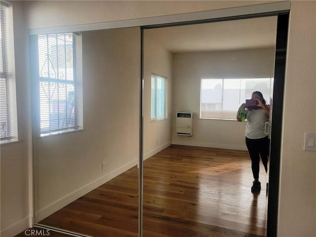 1136 Arapahoe St, Los Angeles, CA 90006 - hall featuring heating unit, wood finished floors, and baseboards