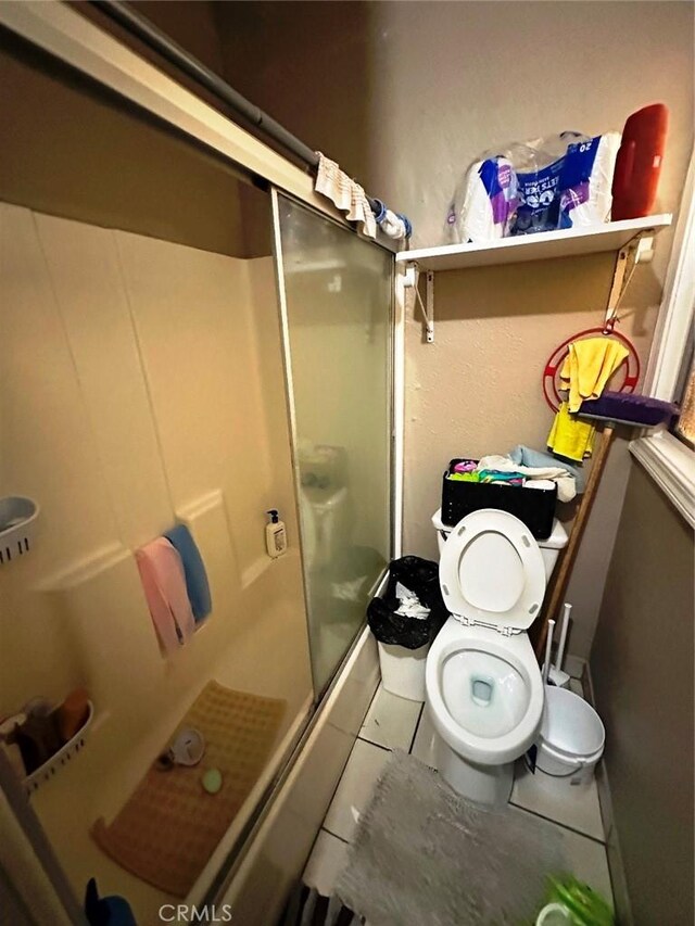 1136 Arapahoe St, Los Angeles, CA 90006 - bathroom with a shower with shower door, tile patterned floors, and toilet