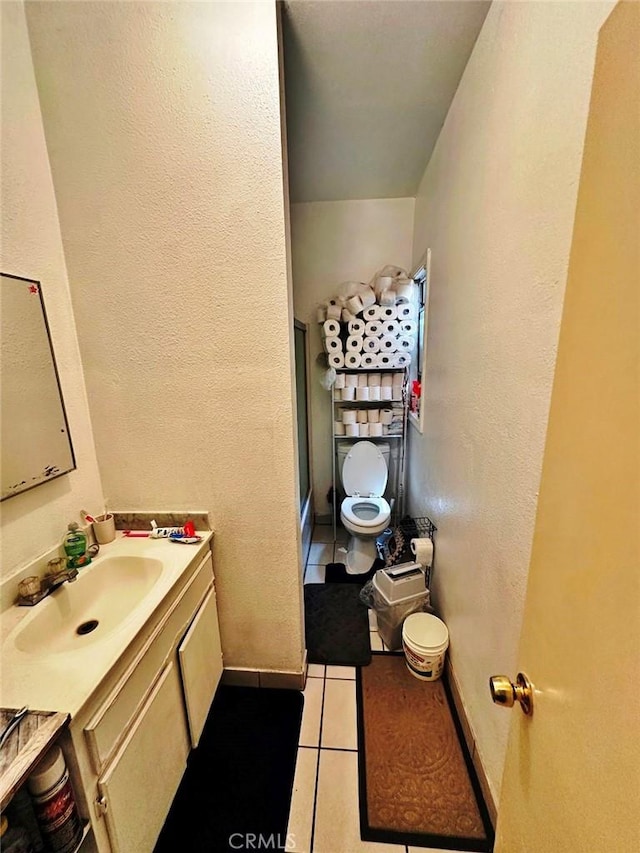 1136 Arapahoe St, Los Angeles, CA 90006 - bathroom with vanity, tile patterned floors, a stall shower, toilet, and a textured wall