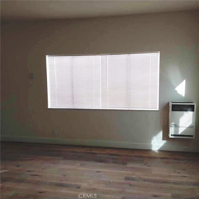 1136 Arapahoe St, Los Angeles, CA 90006 - unfurnished room featuring heating unit, wood finished floors, and baseboards