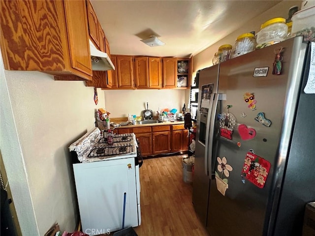 1136 Arapahoe St, Los Angeles, CA 90006 - kitchen with stainless steel refrigerator with ice dispenser, under cabinet range hood, brown cabinetry, and wood finished floors
