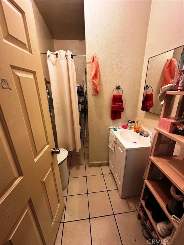 1136 Arapahoe St, Los Angeles, CA 90006 - bathroom featuring tile patterned flooring, vanity, curtained shower, and a textured wall