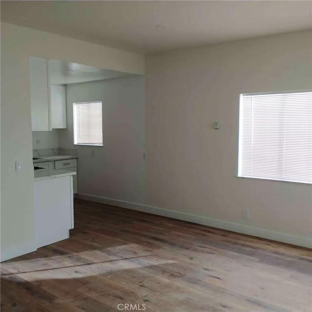 1136 Arapahoe St, Los Angeles, CA 90006 - kitchen featuring white cabinets, hardwood / wood-style floors, light countertops, and baseboards
