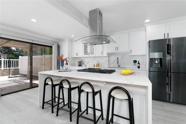 23064 Paseo De Terrado Unit 2, Diamond Bar, CA 91765 - kitchen with black fridge, island range hood, stainless steel gas cooktop, white cabinets, and ornamental molding