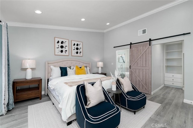 23064 Paseo De Terrado Unit 2, Diamond Bar, CA 91765 - bedroom with a barn door, wood finished floors, crown molding, baseboards, and recessed lighting