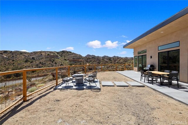 5890 Olema Rd, Yucca Valley, CA 92284 - view of yard with a mountain view, a patio area, and a fire pit