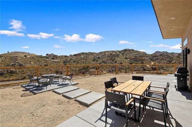 5890 Olema Rd, Yucca Valley, CA 92284 - view of patio with a mountain view, outdoor dining space, and a grill