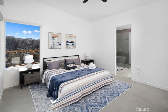 5890 Olema Rd, Yucca Valley, CA 92284 - bedroom with baseboards, connected bathroom, a mountain view, and a ceiling fan