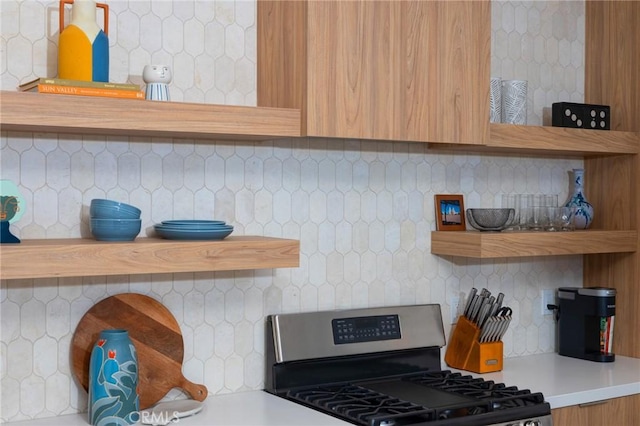5890 Olema Rd, Yucca Valley, CA 92284 - kitchen with stainless steel range with gas cooktop, open shelves, decorative backsplash, and light countertops