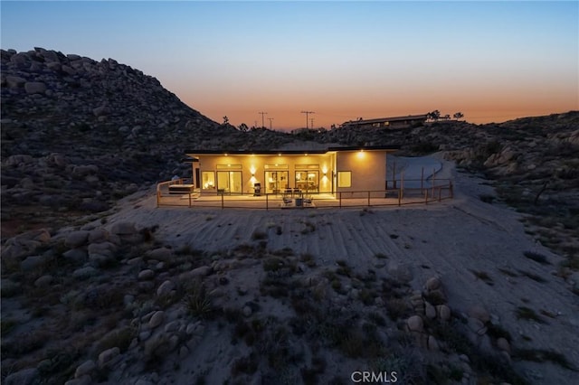 5890 Olema Rd, Yucca Valley, CA 92284 - back of house at dusk featuring a mountain view