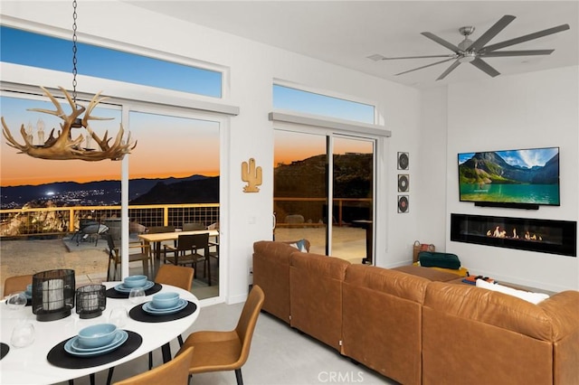 5890 Olema Rd, Yucca Valley, CA 92284 - living area with a glass covered fireplace and a ceiling fan
