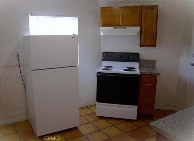 73752 Crestview Dr Unit 29, Palms, CA 92277 - kitchen featuring white appliances, range hood, brown cabinets, and light tile patterned flooring