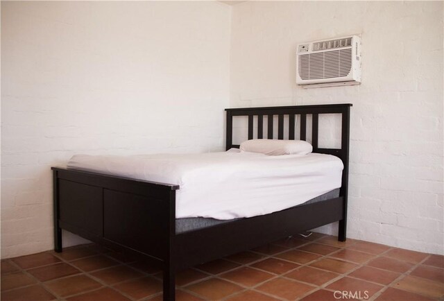 73752 Crestview Dr Unit 29, Palms, CA 92277 - bedroom featuring a wall mounted AC and tile patterned floors