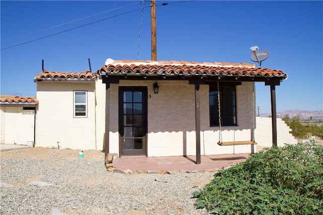 73752 Crestview Dr Unit 29, Palms, CA 92277 - rear view of house with a tile roof and stucco siding