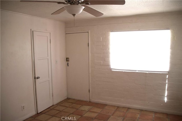 73752 Crestview Dr Unit 29, Palms, CA 92277 - unfurnished room featuring ceiling fan and brick wall