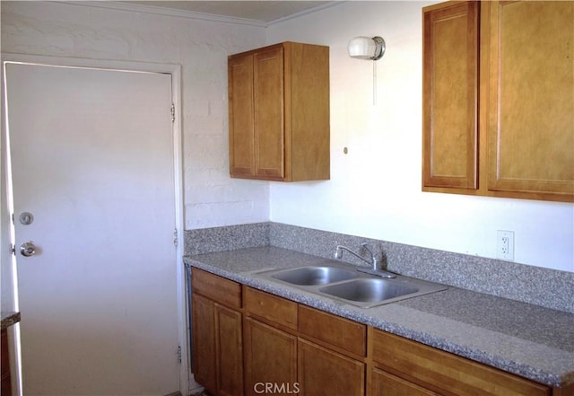 73752 Crestview Dr Unit 29, Palms, CA 92277 - kitchen with a sink, brown cabinets, and crown molding
