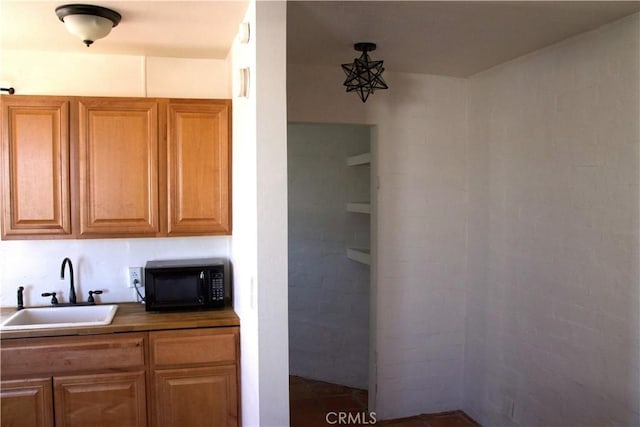 73752 Crestview Dr Unit 29, Palms, CA 92277 - kitchen featuring black microwave, a sink, and brown cabinets