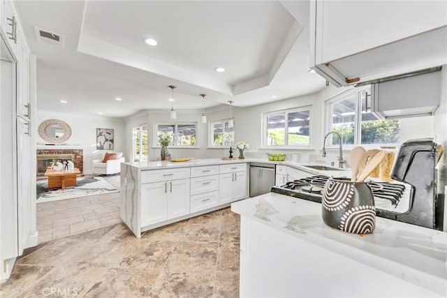 2563 Pepperdale Dr, Rowland Heights, CA 91748 - kitchen with a sink, a peninsula, white cabinetry, stainless steel dishwasher, and decorative light fixtures