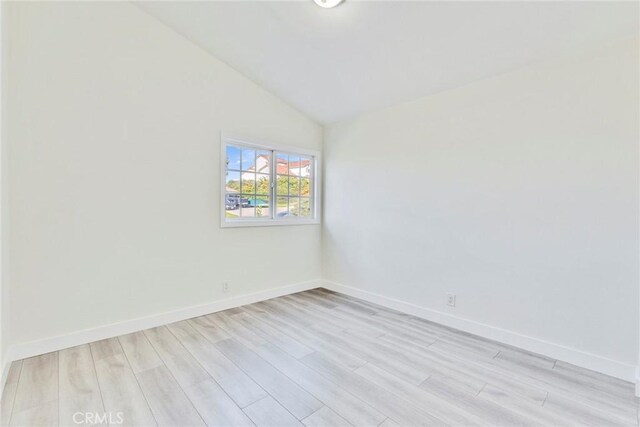 2563 Pepperdale Dr, Rowland Heights, CA 91748 - spare room with vaulted ceiling, light wood-style flooring, and baseboards