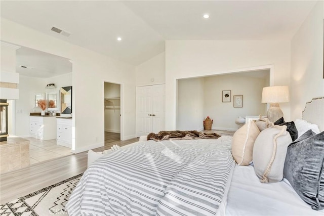 2563 Pepperdale Dr, Rowland Heights, CA 91748 - bedroom featuring vaulted ceiling, light wood-style flooring, ensuite bathroom, a walk in closet, and baseboards