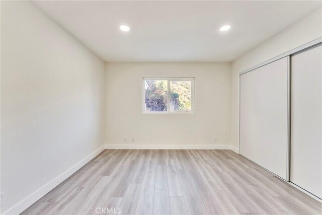 2563 Pepperdale Dr, Rowland Heights, CA 91748 - unfurnished bedroom with light wood-style floors, recessed lighting, a closet, and baseboards